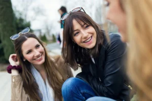 three young women talking laughing street 1301 3350